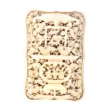 A fine 19th Century Chinese carved ivory visiting card case of shaped rectangular outline, one