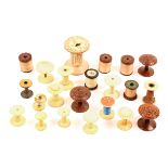 A collection of reels and reel holders comprising a set of three coquilla nut reel holders, three