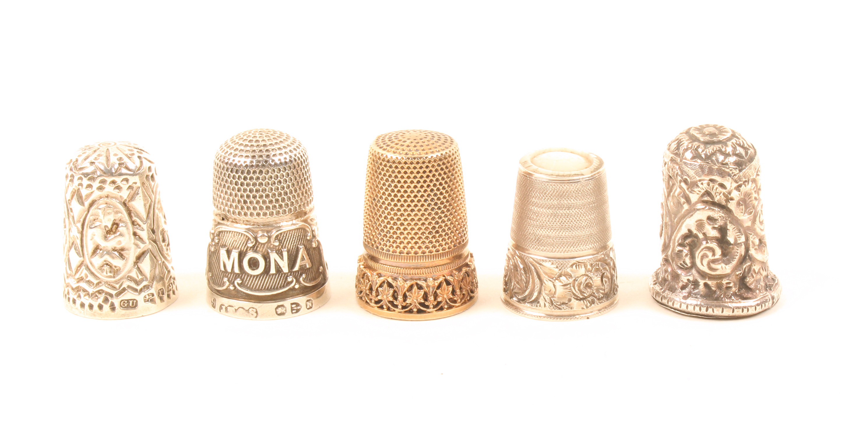 Five silver thimbles comprising an example with mother of pearl top, an example with four oval