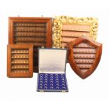 Five thimble frames and cases, comprising a carved and pierced giltwood rectangular frame fitted