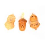 Three vegetable ivory thimble cases all of acorn form one with silver thimble, one with Stanhope (