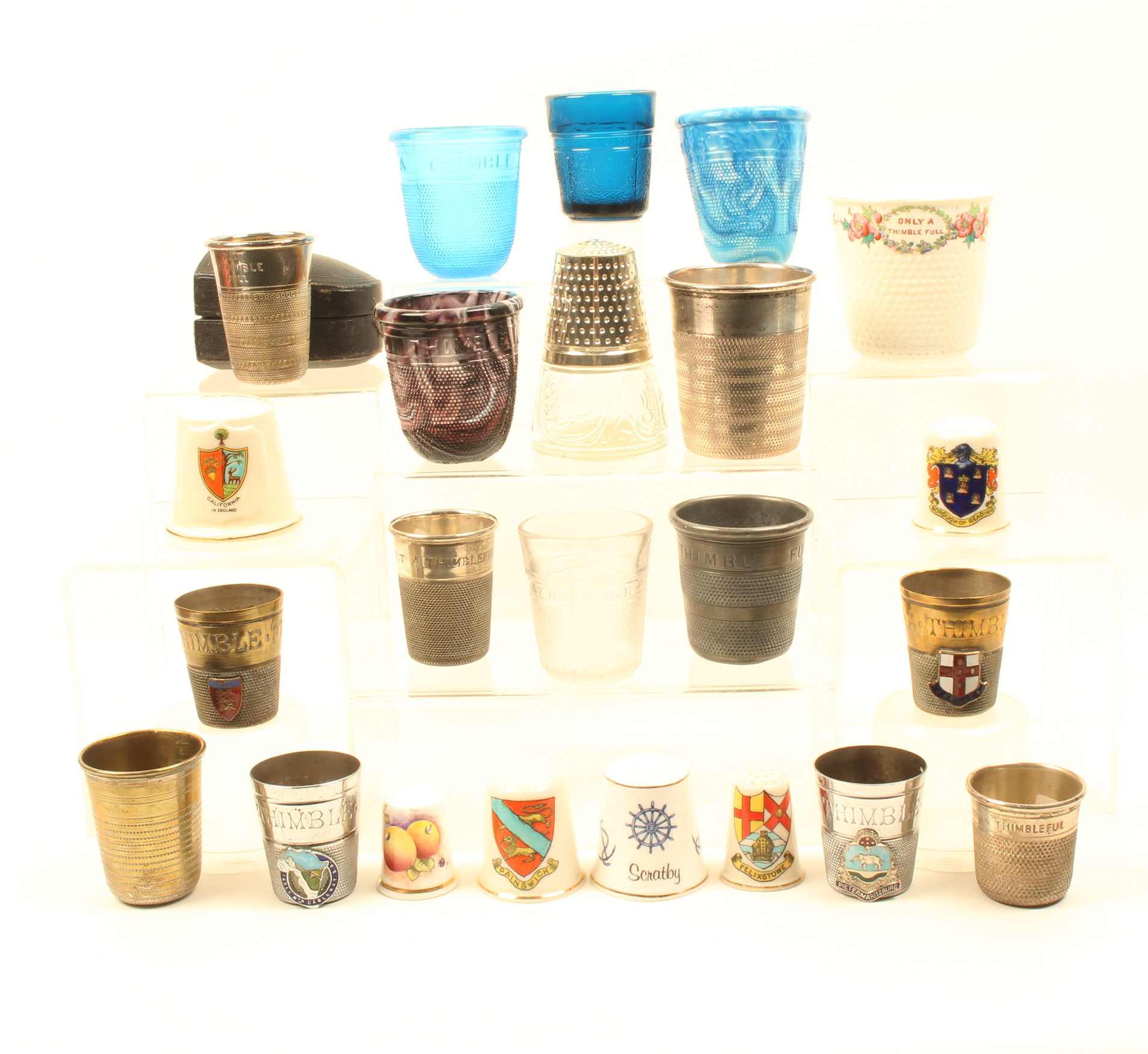 A collection of ‘Just A Thimble Full’ measures and large decorative thimbles, comprising ten