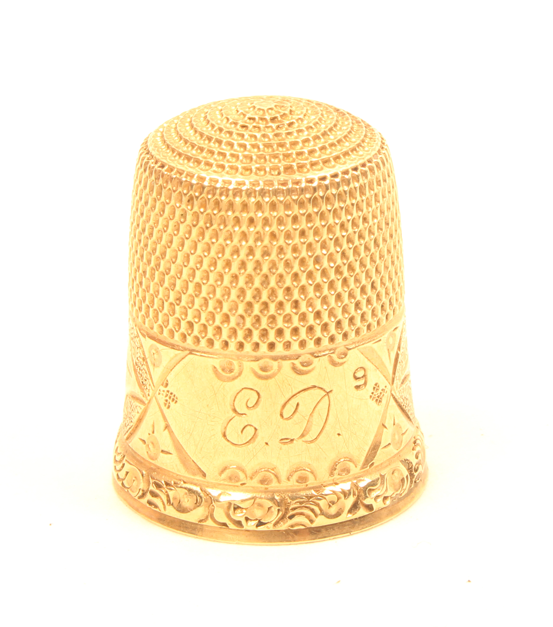 An American gold thimble, initialled ‘ED’ within an ivy and frosted frieze over a raised scroll