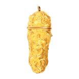 A late 18th Century gilded etui decorated with fruit, flowers, leaf scrolls and female figures,