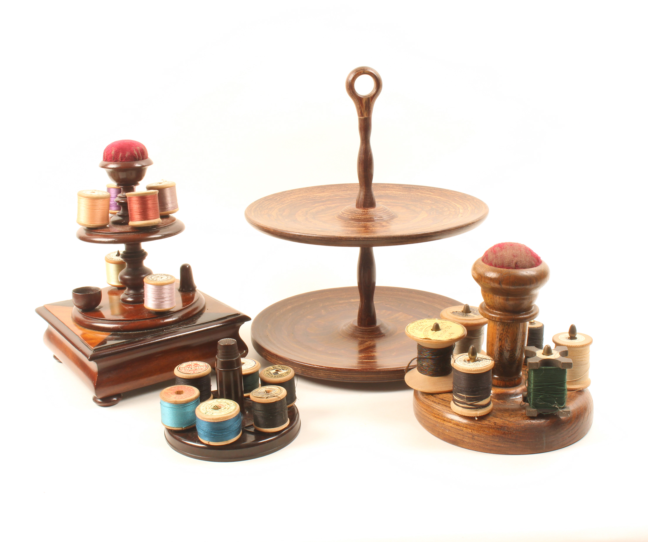 A 19th Century mahogany reel stand of two circular tiers with central pin cushion, the inlaid