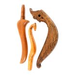 Two knitting sticks and a carved item, comprising a Scandinavian example with horse head finial,