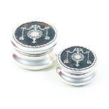 A pair of graduated circular dressing table boxes in silver with inset tortoiseshell lids inlaid