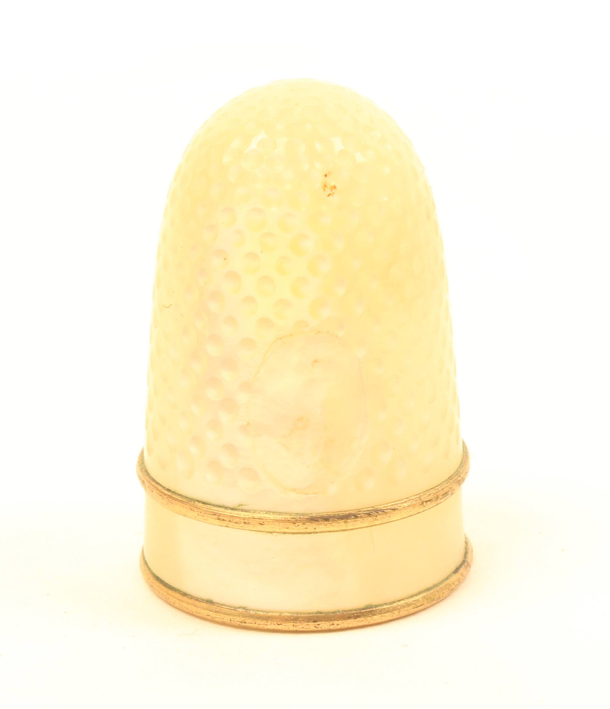 A 19th Century Palais Royal thimble with plain frieze between two gilt bands, lacking oval pansy