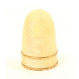 A 19th Century Palais Royal thimble with plain frieze between two gilt bands, lacking oval pansy