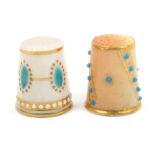 Two early 20th Century Worcester thimbles one with a puce ground decorated with slanting bands of