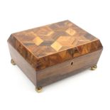 An early 19th Century Tunbridge ware rosewood sewing box of sarcophagal form the lid in cube work