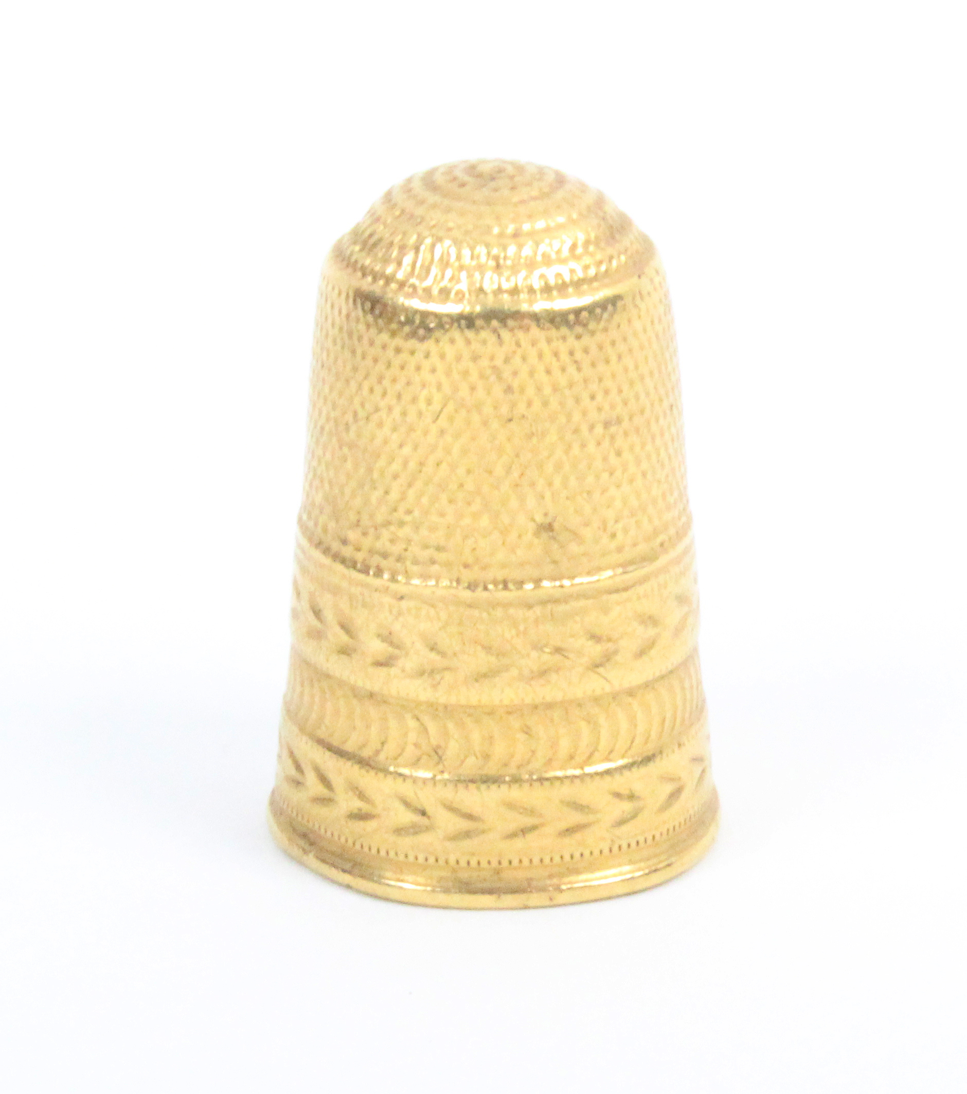 A gold thimble, the frieze with three decorative bands, general wear (From the collection of the