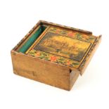 An early 19th Century painted Tunbridge ware whitewood box, the sliding lid with a view of