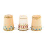 Three early 20th Century Royal Worcester porcelain thimbles, two decorated on a puce ground with