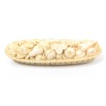 A fine early 19th Century carved ivory Dieppe needlecase in the form of an oval basket of fruit