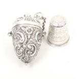 A Victorian silver thimble case with silver thimble, the case of egg form decorated with ïCÍ scrolls