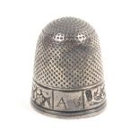 An 18th Century English silver thimble, the leaf scroll and floral frieze with a rectangular panel