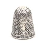 A 17th Century silver thimble cover probably German, the chain ground with four architectural