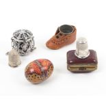 Four thimble cases comprising a silver example for a chatelaine, on chain, pierced and decorated