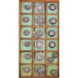 A collection of eighteen silver buttons comprising a set of pierced floral and trellis examples,