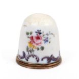 An 18th Century South Staffordshire enamel thimble decorated with single flowers and a flower