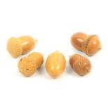 Five thimble cases all in vegetable ivory comprising four acorn form examples, largest 5.5cm and