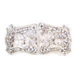 An attractive pierced and cast two piece silver buckle one half with a seated man with scythe the