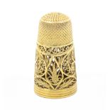 An attractive early 19th Century silver gilt filigree thimble of tall form, originally with screw