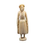 A good 19th Century French figural ivory needlecase in the form of a standing fisher woman in