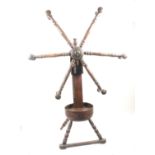 An early 19th Century floor standing wool winder in stained pine and fruitwood on four turned legs