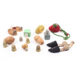 A group of thimble cases and thimbles comprising a pair of material thimble slippers with pin