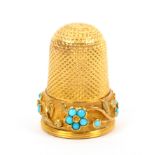 A 19th Century gold thimble the raised frosted frieze with a trailing band of flower heads comprised