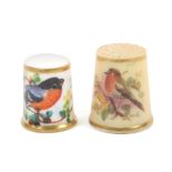 Two English porcelain thimbles comprising a Worcester example painted with a robin on a flowering