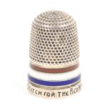 A silver thimble with red white and blue enamel frieze the rim inscribed ïA Stitch For The Red,