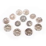 Silver buttons comprising a set of four floral cast and pierced examples, Birmingham, 1900 by L