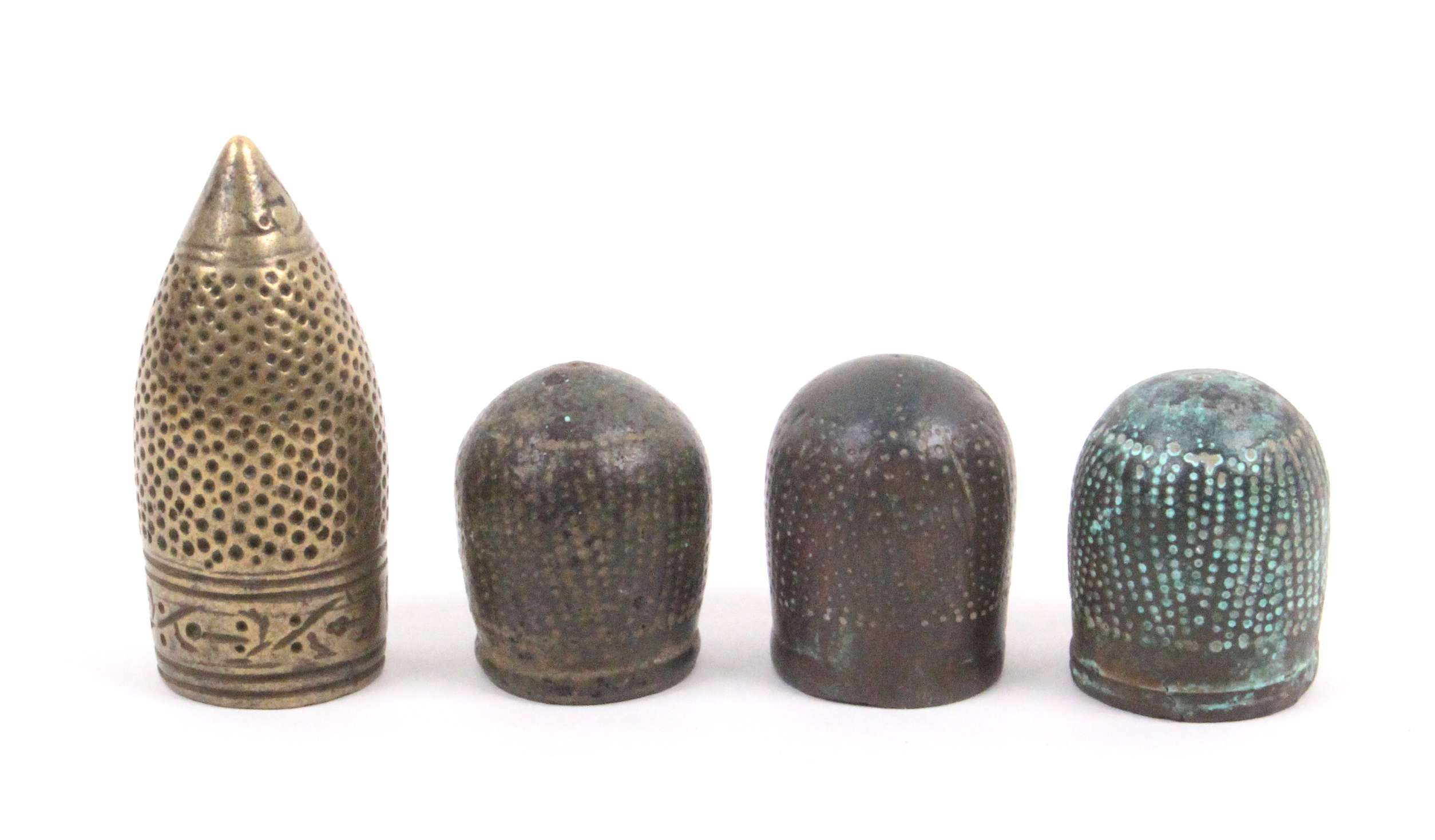 Four early excavated thimbles comprising a bronze Hispano-Moresque example, probably 15th Century,
