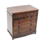 A Victorian rosewood miniature chest of drawers, of two short and three long graduated drawers,