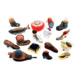 A collection of larger format pin cushions, nine in the form of shoes in various materials,