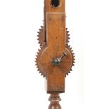 An early 19th Century walnut or fruitwood wool winder the bobbin turned frame on four bun feet