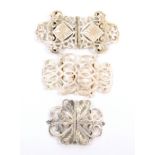 Three pierced scroll work buckles, comprising a silver plated example, 10cm, a silver example, marks