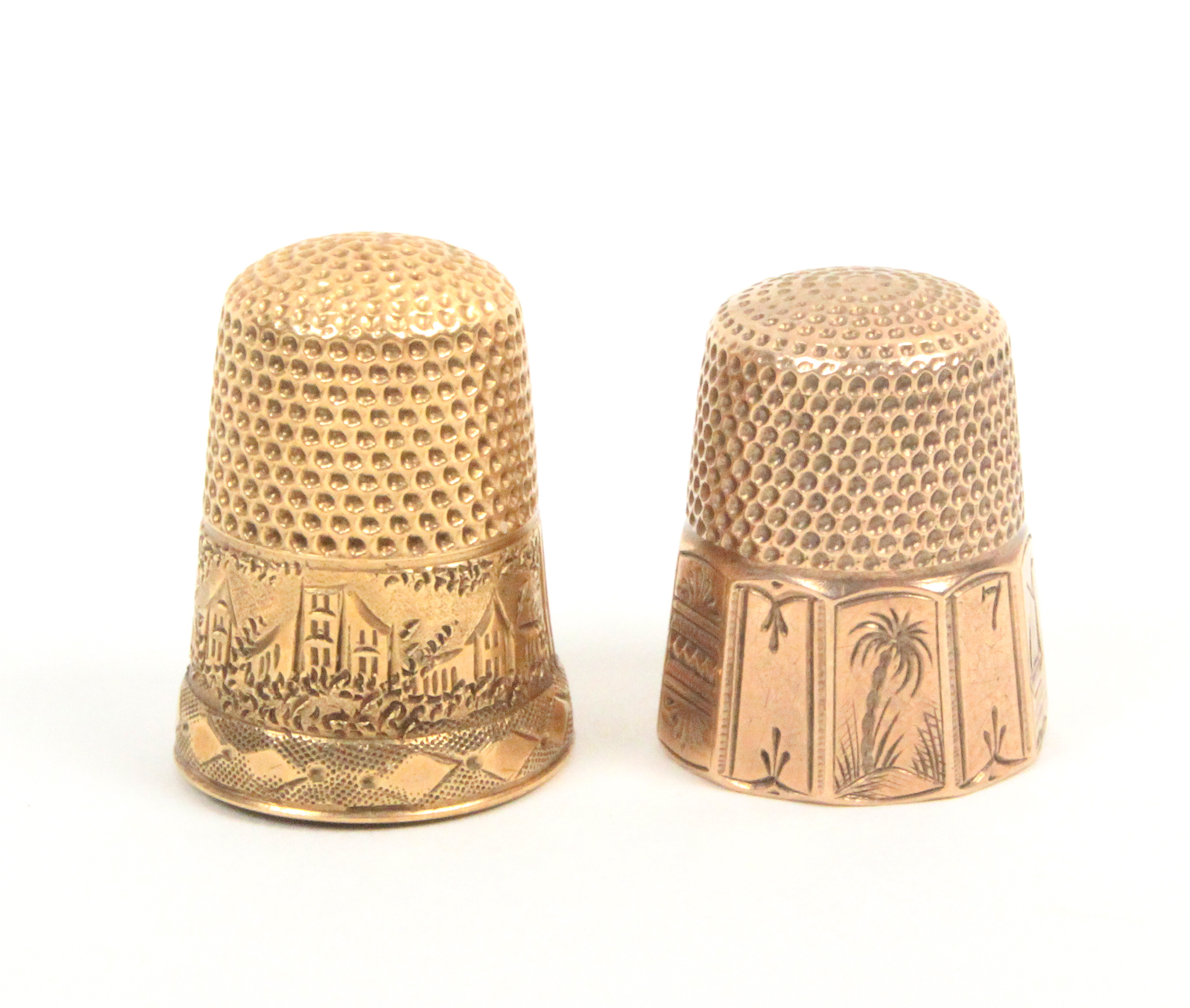 Two American gold thimbles one with engraved panels including a ship, a palm tree and a