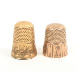 Two American gold thimbles one with engraved panels including a ship, a palm tree and a