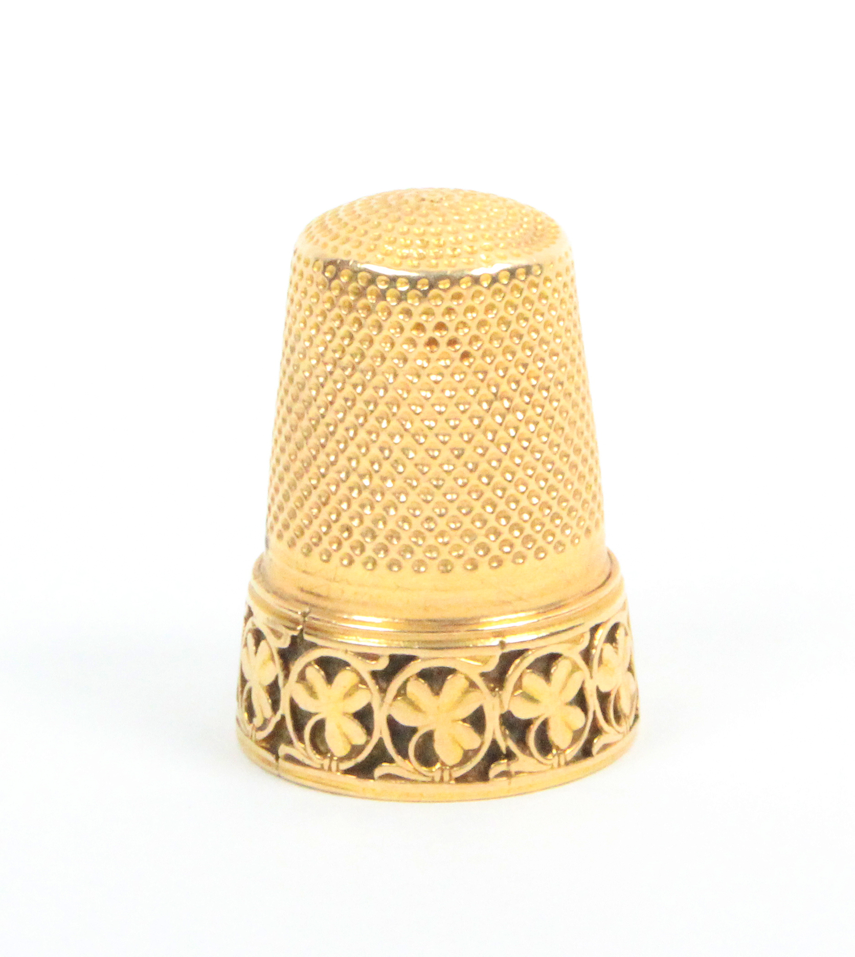 A gold thimble, the frieze with a band of circles enclosing leaves (From the collection of the