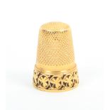 A gold thimble, the frieze with a band of circles enclosing leaves (From the collection of the