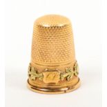 A 19th Century two colour gold thimble the frosted frieze with an initialled cartouche ïCVÍ within a