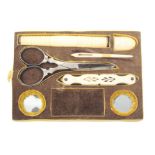 A small sewing tray, flush fitted in brown velvet with pierced bone tweezer/ear spoon, a pair of