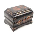 A late 19th Century Japanese black ground lacquer sewing box of bombe form decorated with birds,