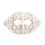 A large pierced and engraved two piece silver buckle each half with flowers and scrolls,