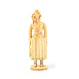 An early 19th Century carved ivory Dieppe fisherwoman needlecase, of standing form, in traditional