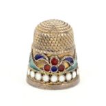 A Russian silver gilt and cloissone enamel thimble with a colourful cloissone frieze over a border
